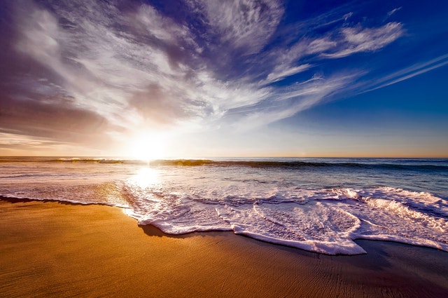 seashore-under-white-and-blue-sky-during-sunset